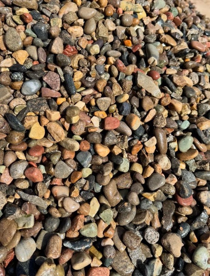 A pile of rocks sitting on top of each other on the ground.