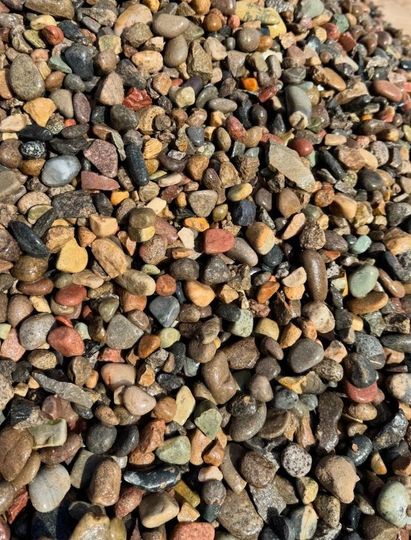 A pile of rocks is sitting on the ground.