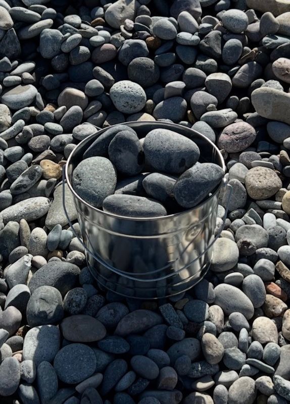 A pile of rocks sitting on top of each other on the ground.
