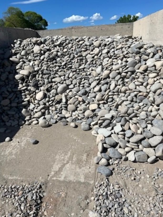 A pile of rocks sitting on top of each other on the ground.