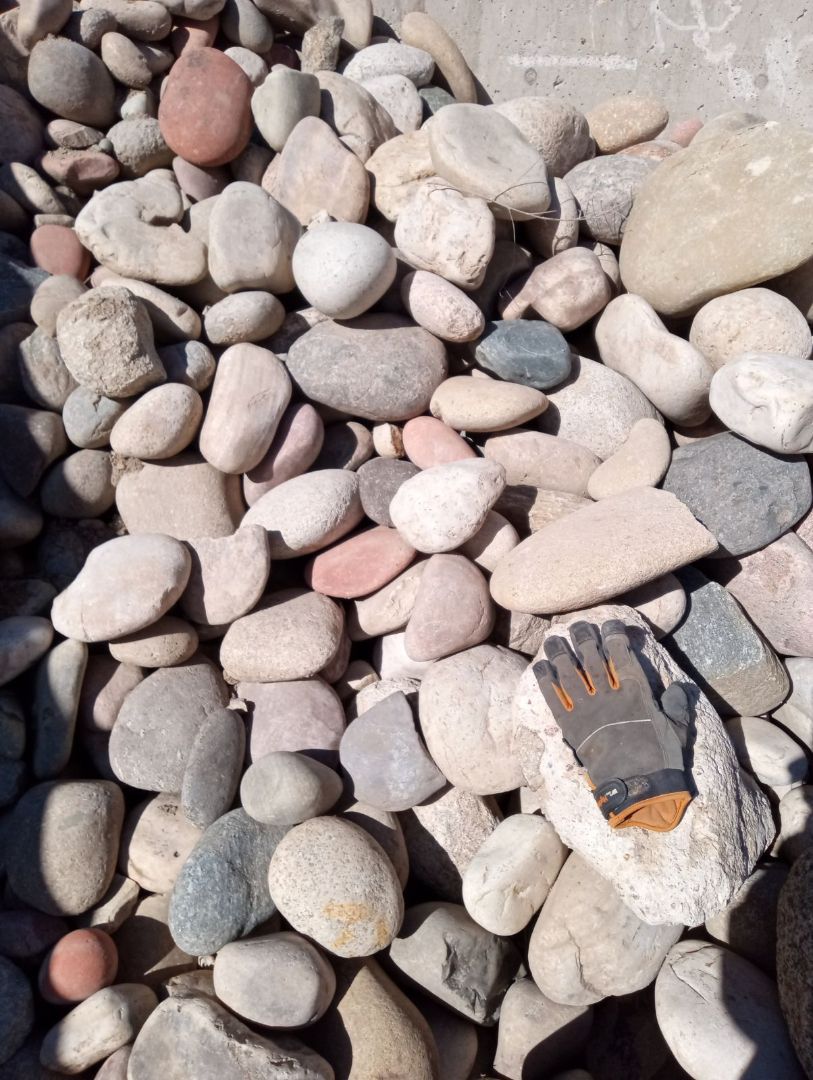 A pile of rocks sitting on top of each other on the ground.