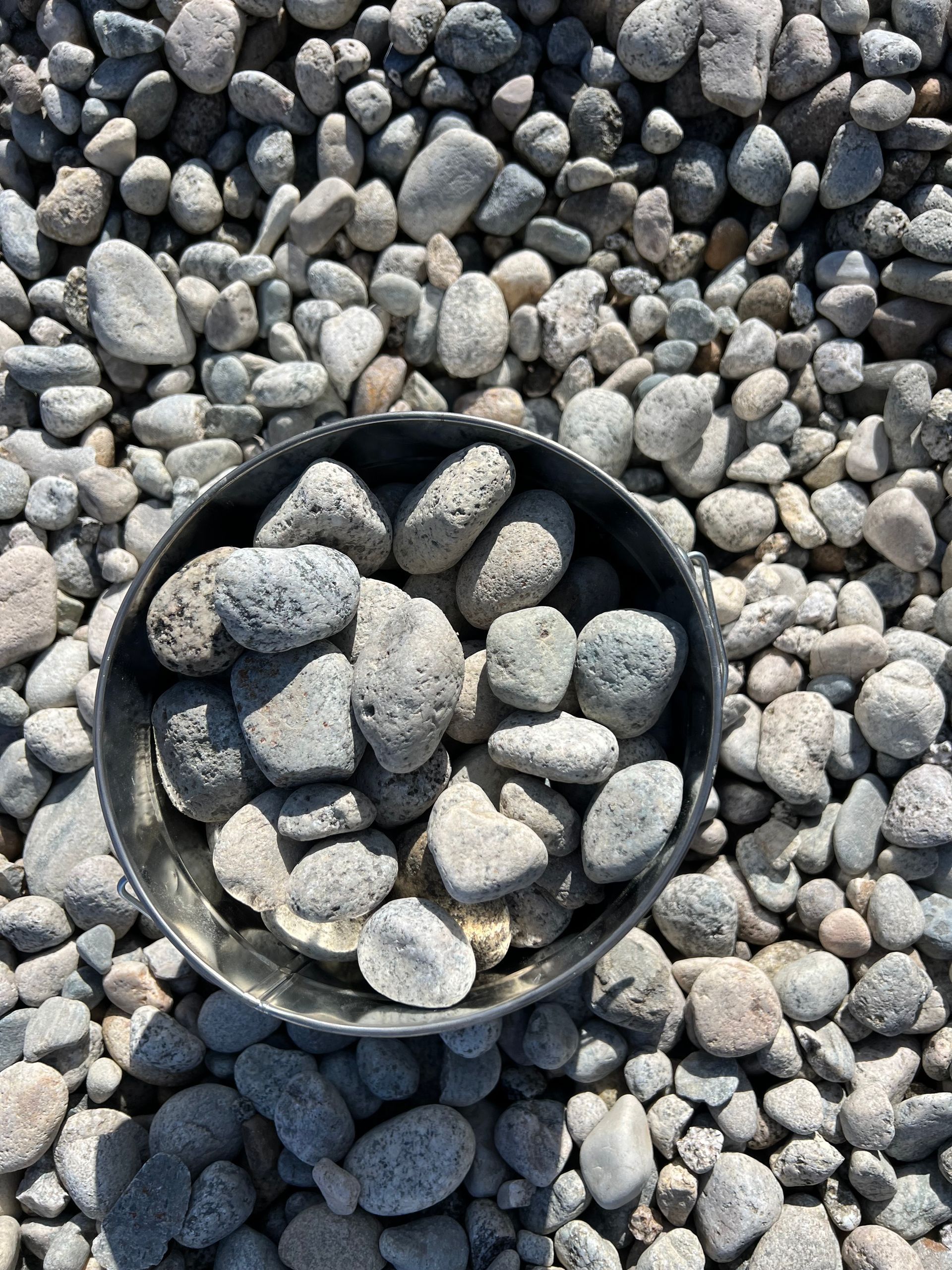 A pile of rocks sitting on top of each other on the ground.