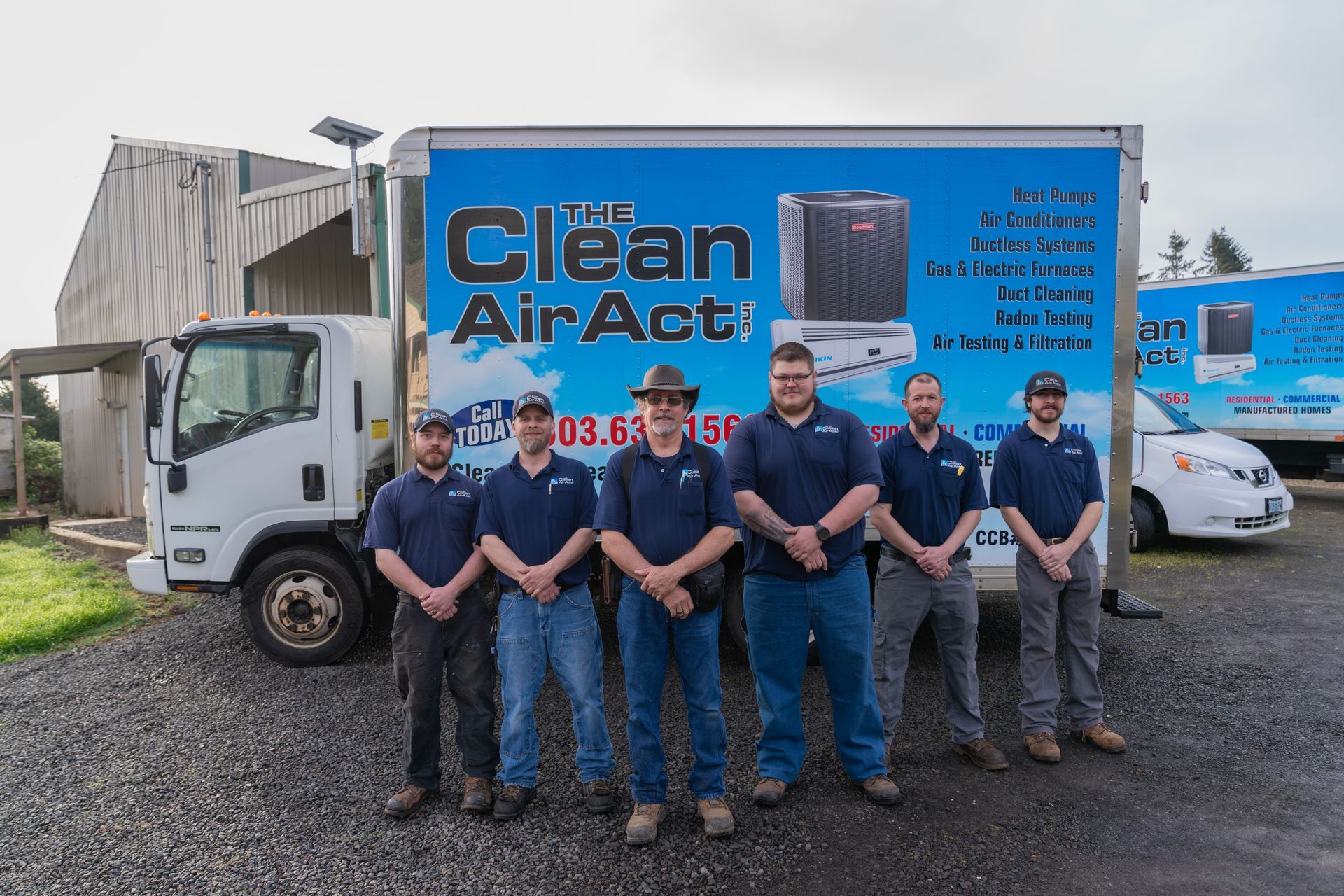 A group of The Clean Air Act Technician are standing in front of a clean air act truck.