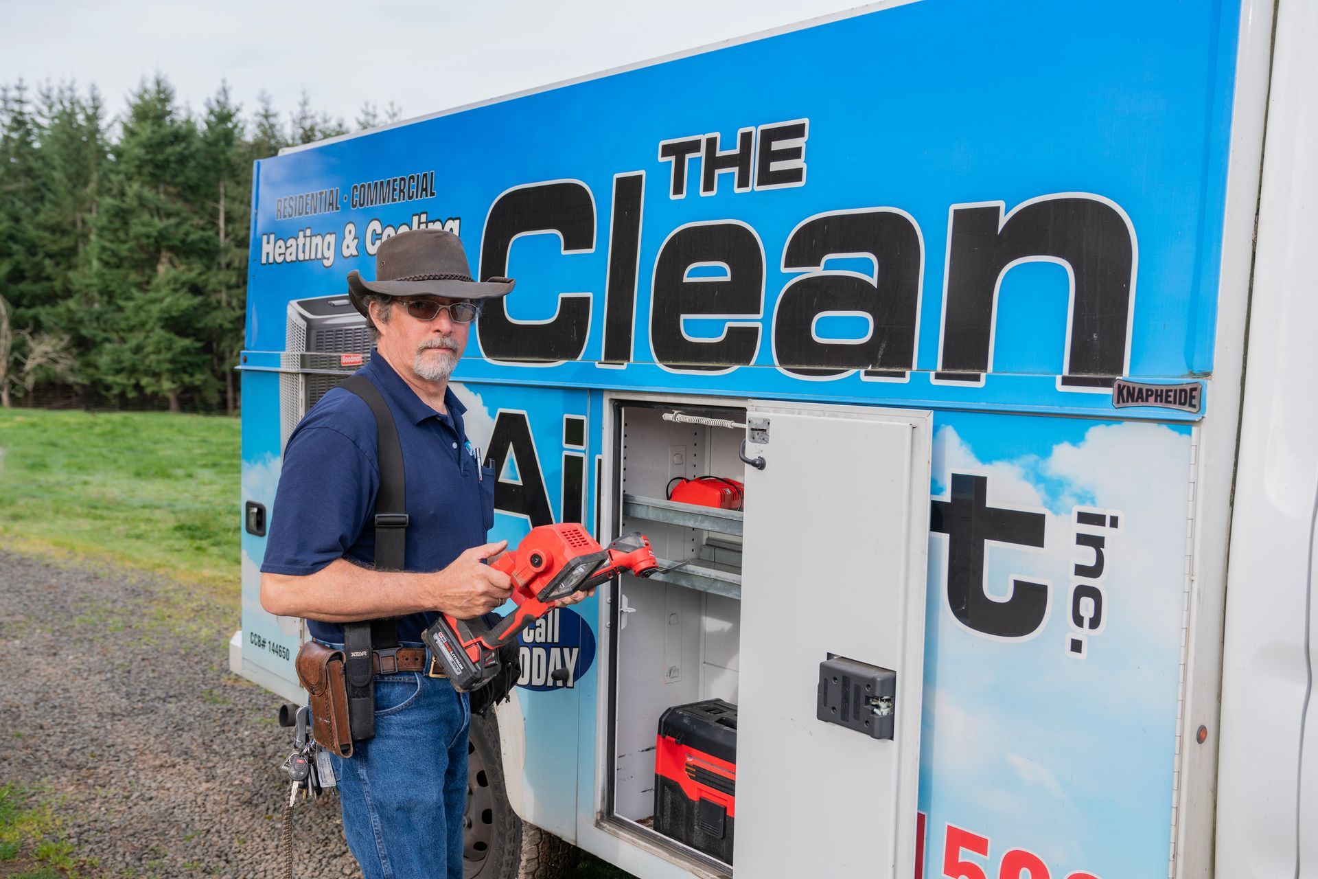 The Clean Air Act Technician is standing in front of a truck that says the clean inc.