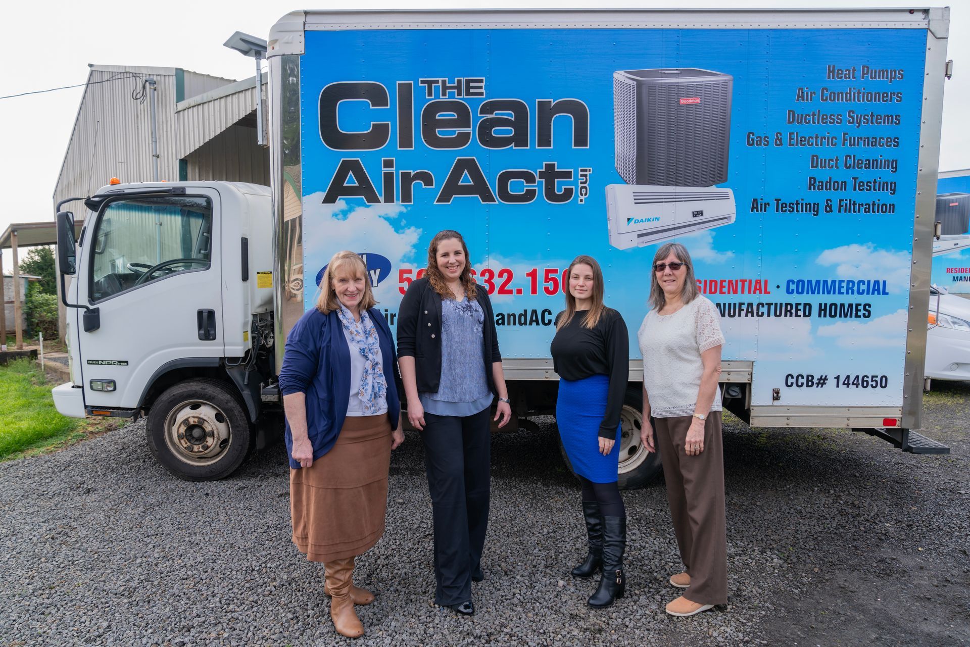 The Clean Air Act employees standing in front of a clean air act truck.