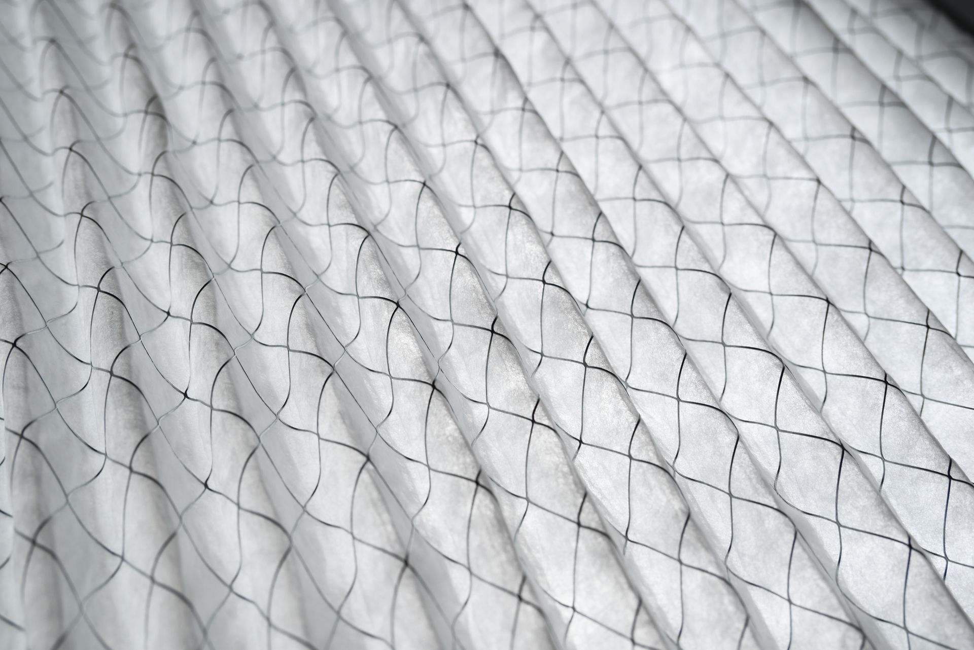 A close up of a white fabric with a black grid pattern