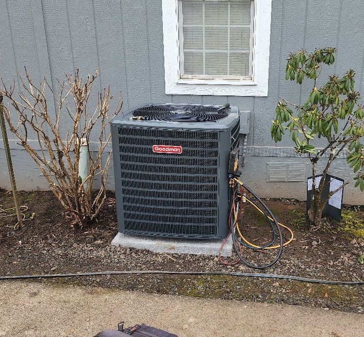 An air conditioner is sitting outside of a house next to a window.
