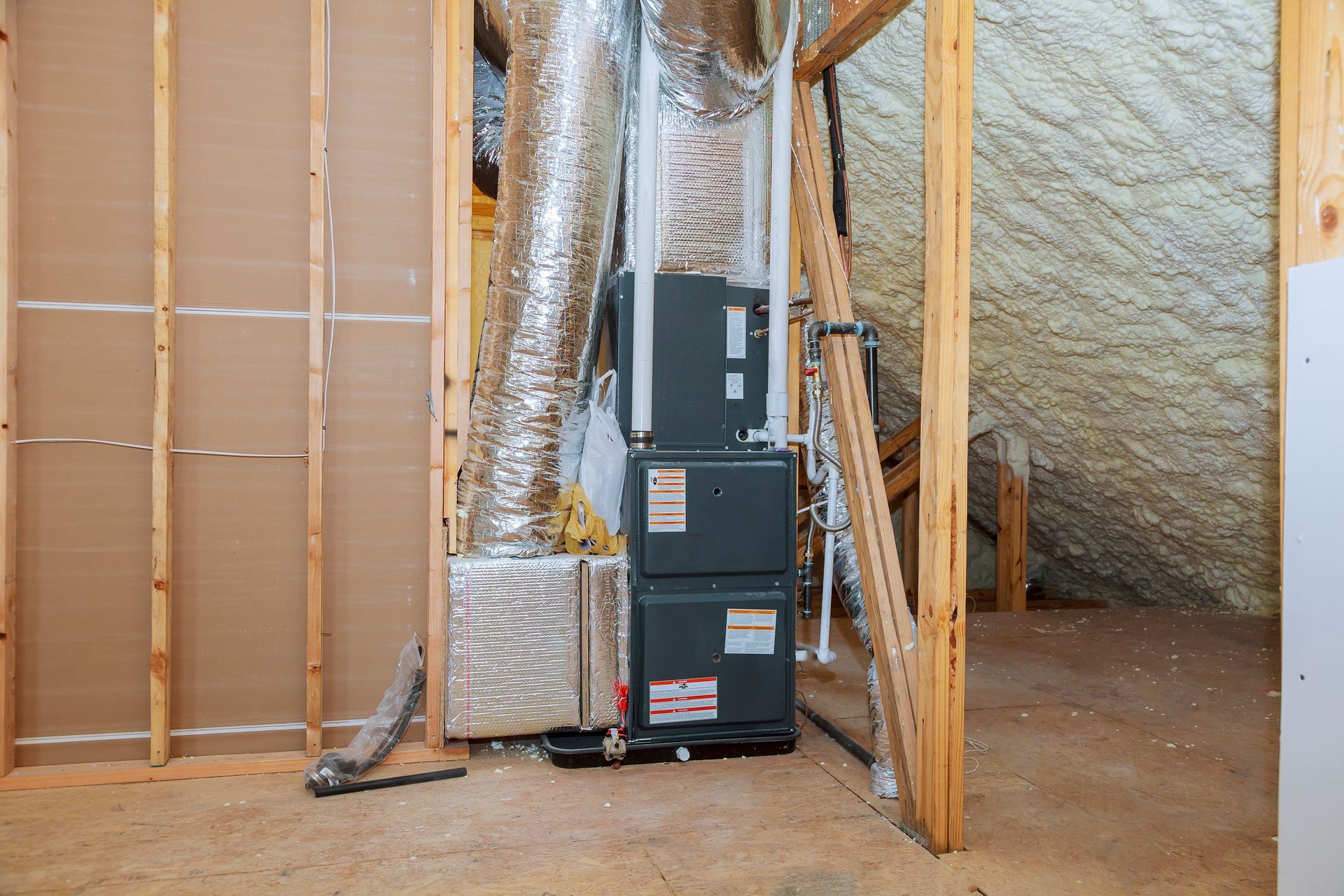There is a furnace in the attic of a house under construction.