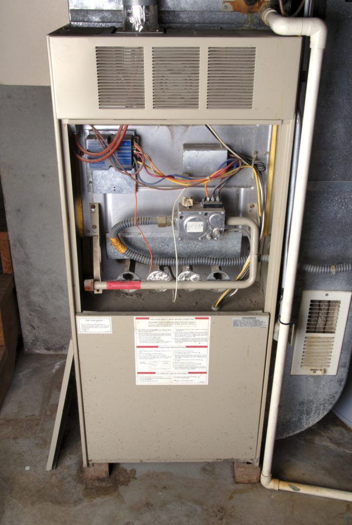 The inside of an electric furnace is shown with the door open.