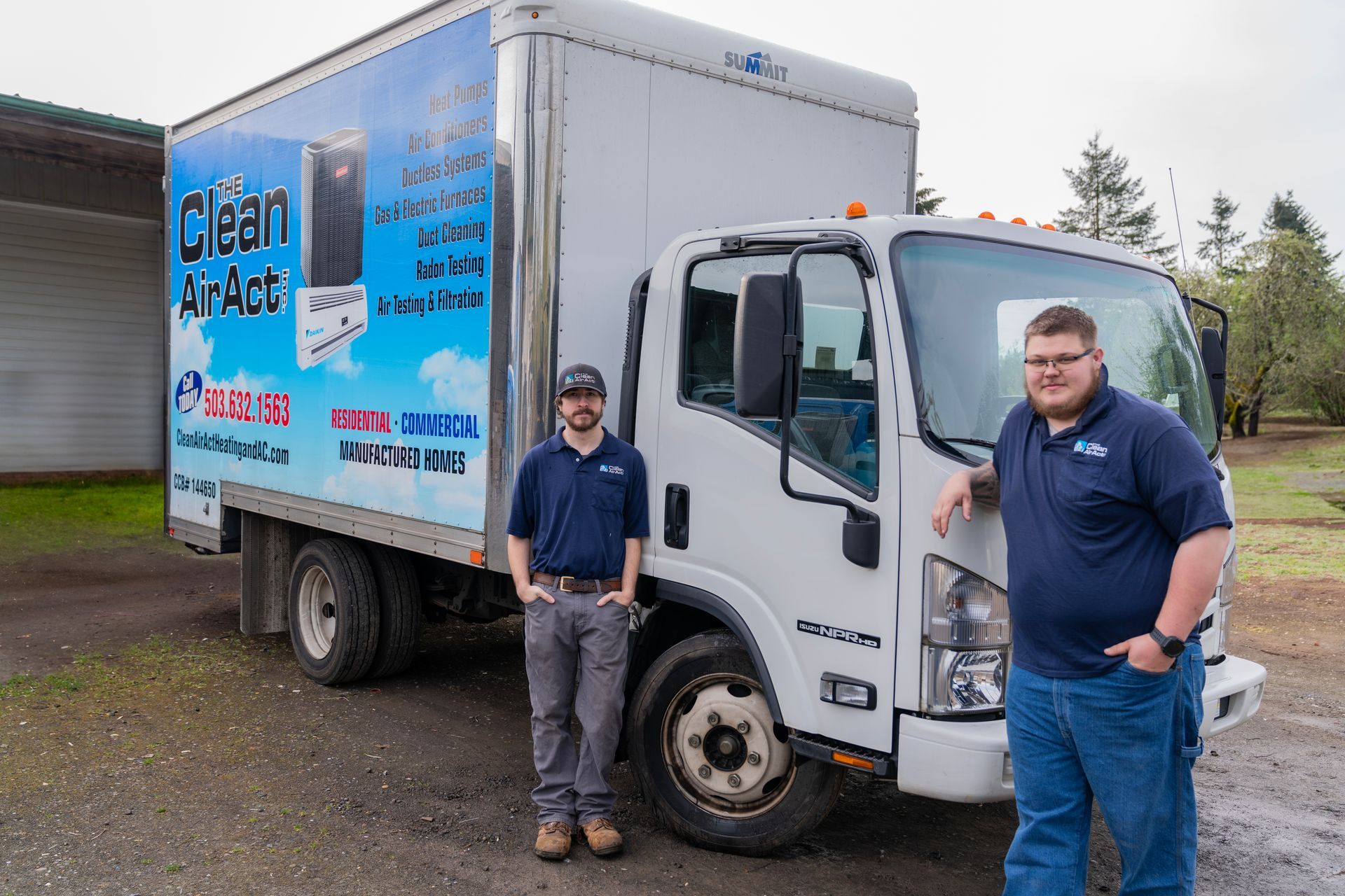 The Clean Air Act Technicians are standing in front of a clean air act truck.