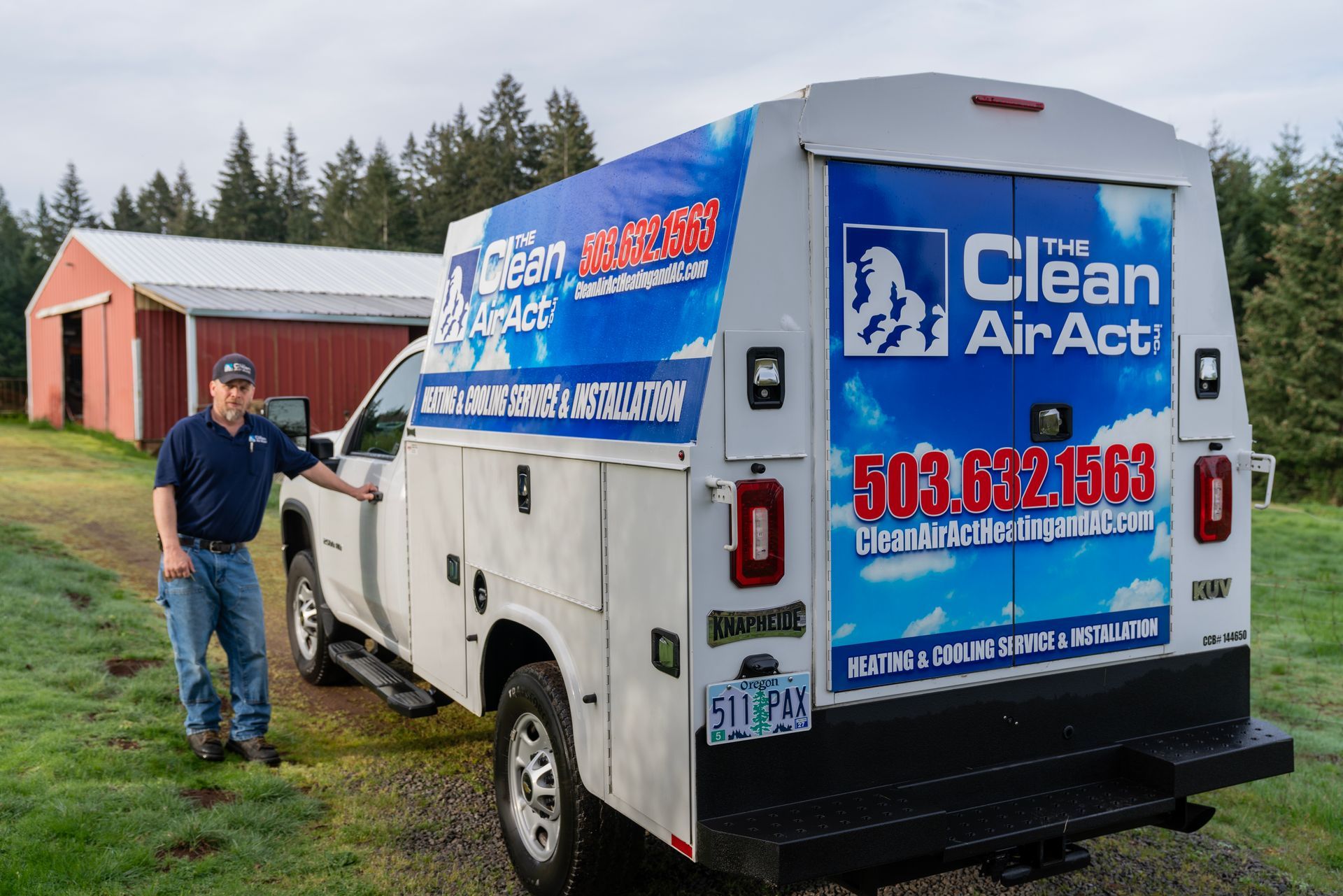 The Clean Air Act Technician is standing next to a clean air act truck.