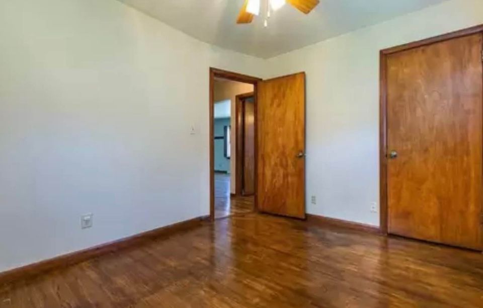Cozy bedroom at Woodlawn with stylish decor, neutral color tones, and ample natural light.
