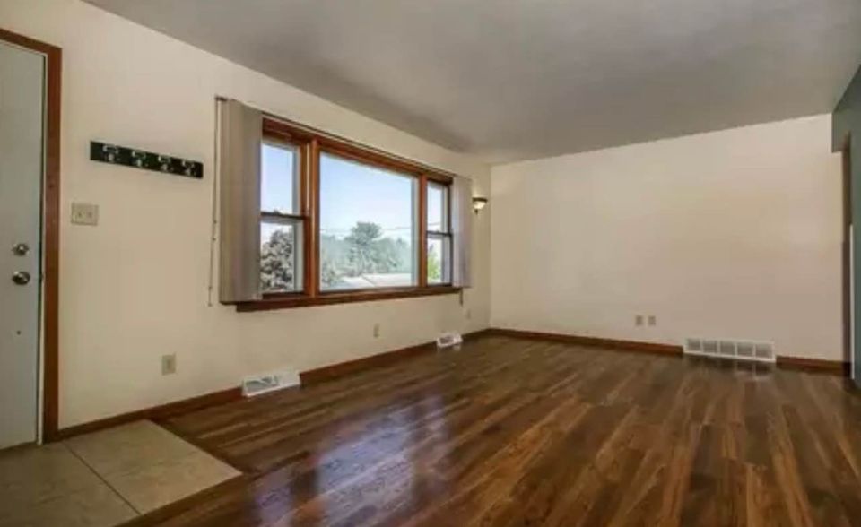 Warm and inviting family room at Woodlawn with a stylish entertainment area and comfortable seating.