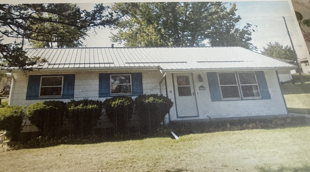 Exterior of home with new siding, patio, and energy-efficient windows by AMC Homes