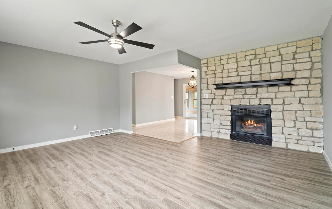 Family room at Lori St with an open floor plan, comfortable seating, and a cozy fireplace.