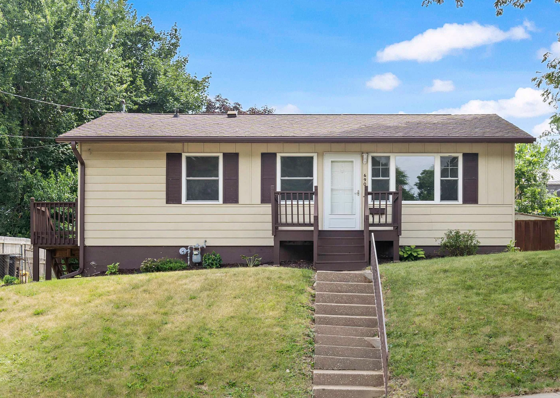 Exterior view of a beautifully remodeled home at 690 Kane St, showcasing fresh paint and landscaping.