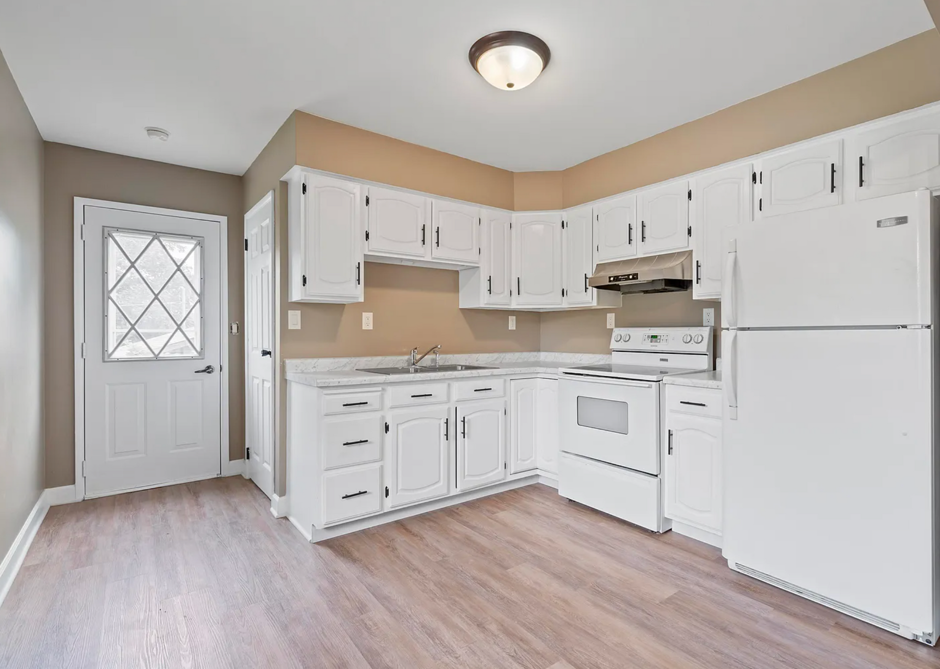 Newly renovated kitchen with modern cabinetry, quartz countertops, and stainless steel appliances on Kane St.