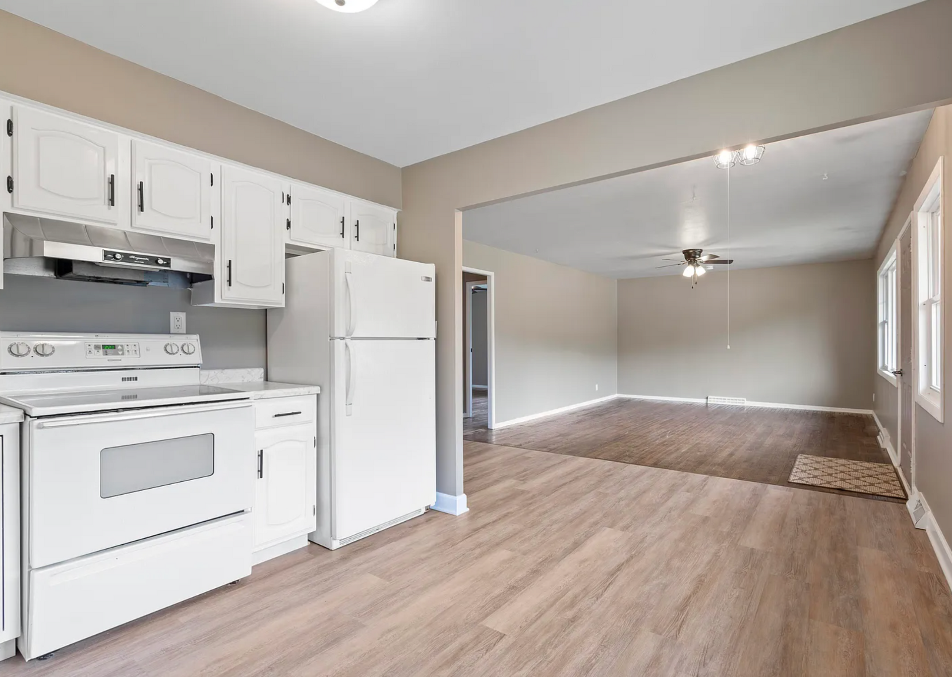Spacious family room renovation featuring cozy furniture, bright lighting, and a stylish entertainment setup.