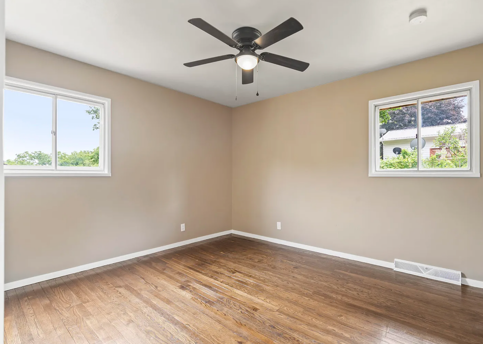 Second remodeled bedroom at Kane St, featuring soft lighting, modern furniture, and a welcoming ambiance.