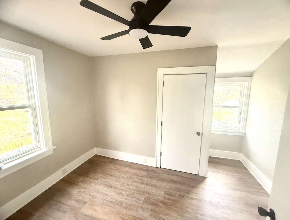 Bright bedroom with new flooring and fresh paint in remodeled Dubuque home