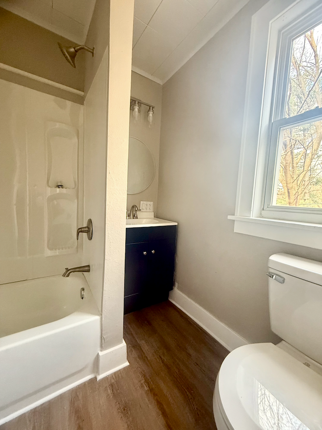 Fully remodeled bathroom with new vanity, mirror, and lighting