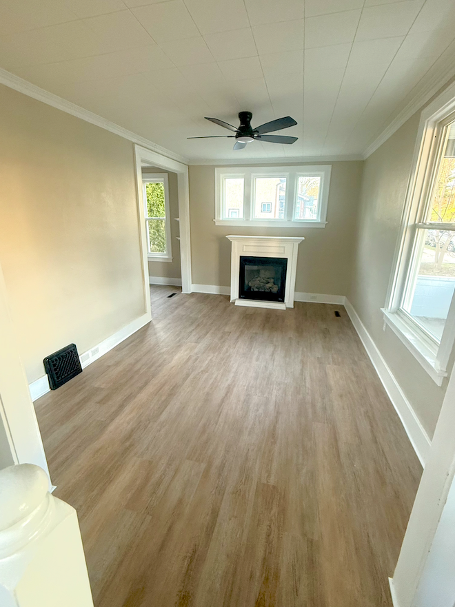 Open-concept living room with new flooring and fresh interior paint