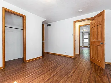 Comfortable bedroom at Simpson House with plush bedding, neutral tones, and a serene atmosphere.