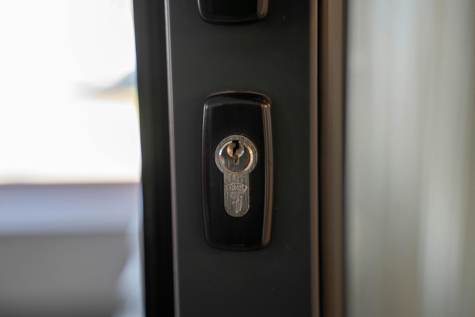 A close up of a door lock with a key in it.