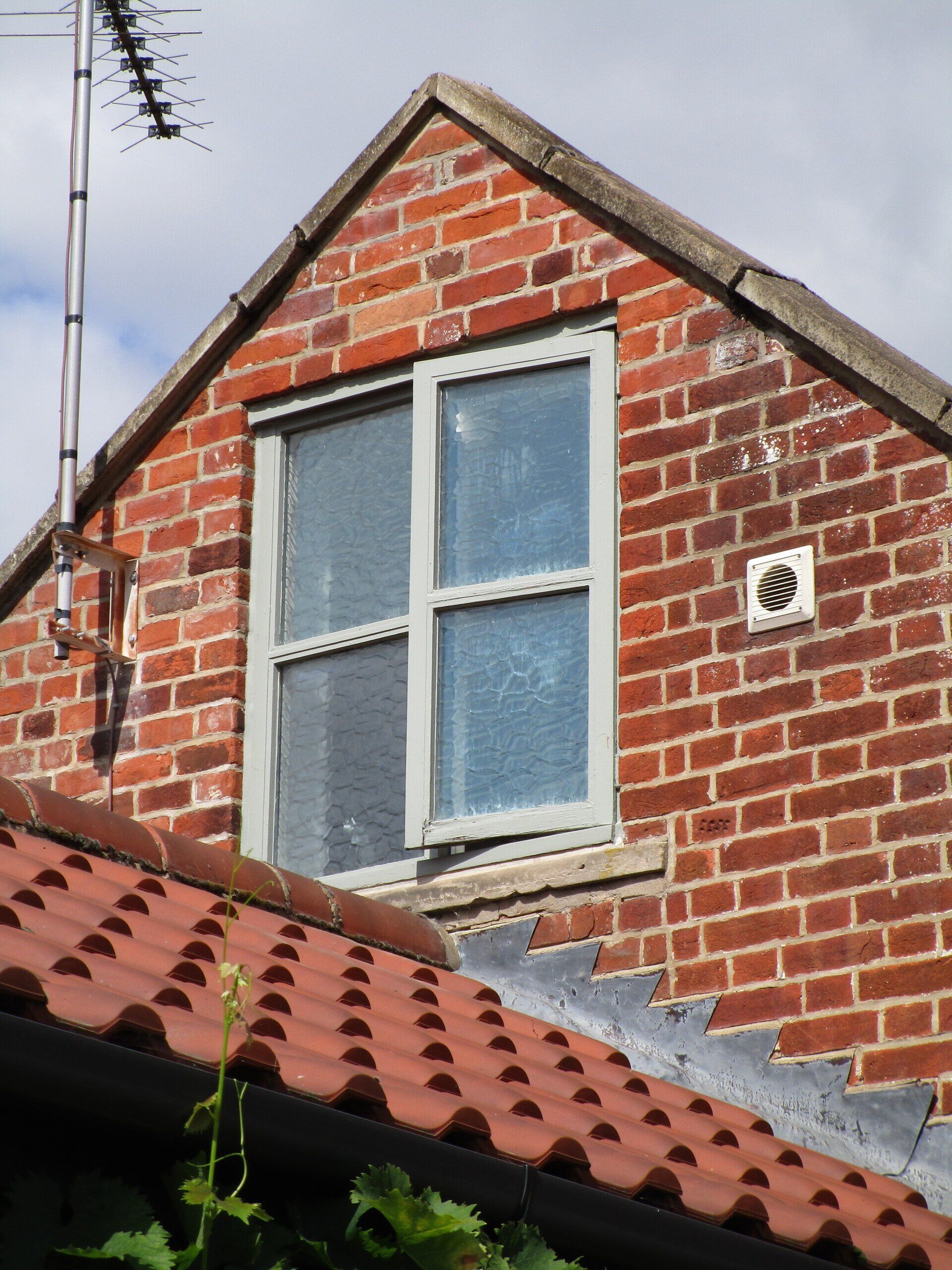 New UPVC Window with French Grey paint on the outside, white wood grain on the inside