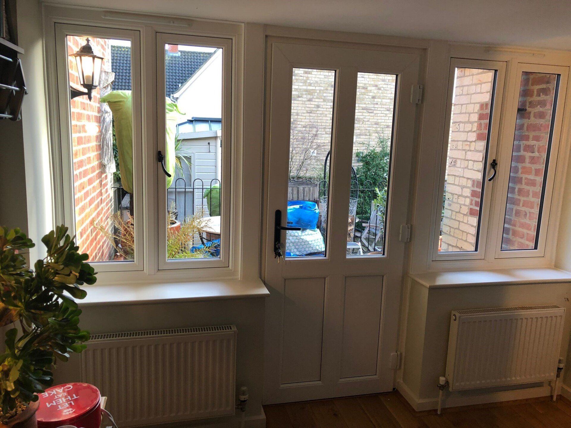 New UPVC Window with French Grey paint on the outside, white wood grain on the inside including Georgian bars and the Heritage Flush System