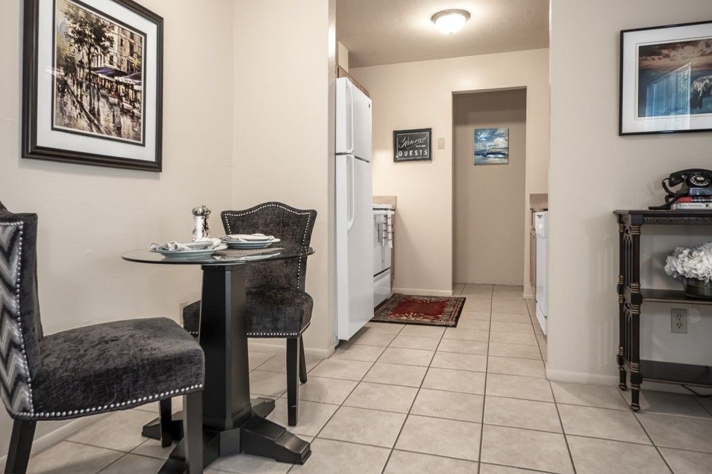 Photo of a kitchen and dining area with tile flooring