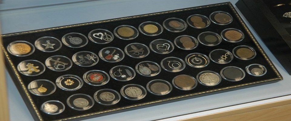 A tray of coins is sitting on a table.