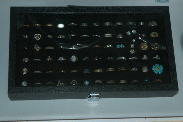A display case filled with lots of rings and earrings