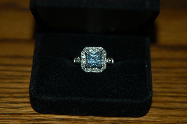 A ring in a black box on a wooden table