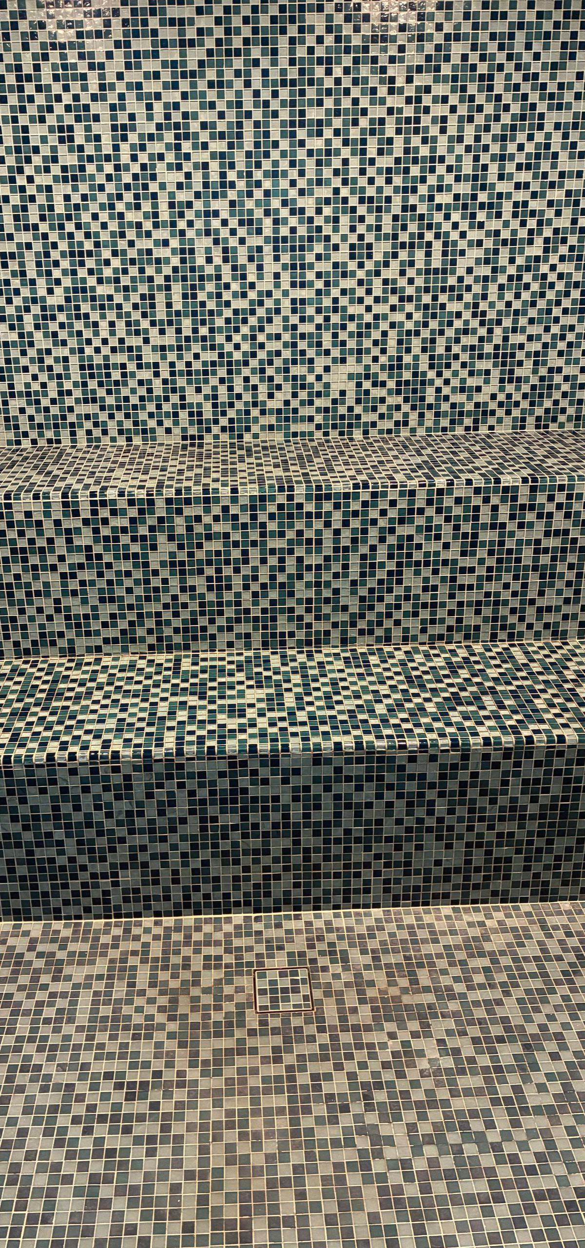 Steps covered in mosaic tiles, vertical view.
