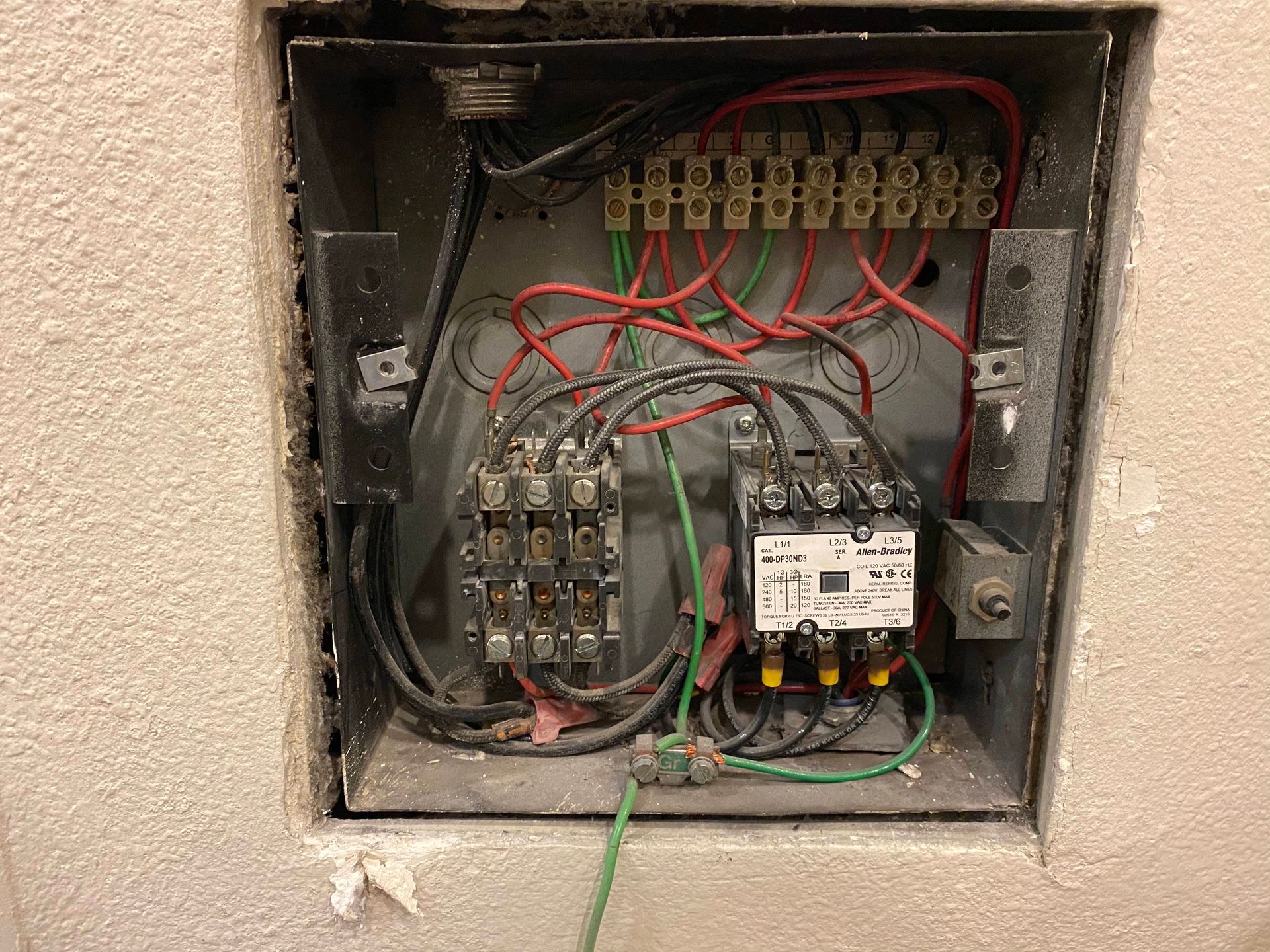 Electrical junction box with wires and terminals.