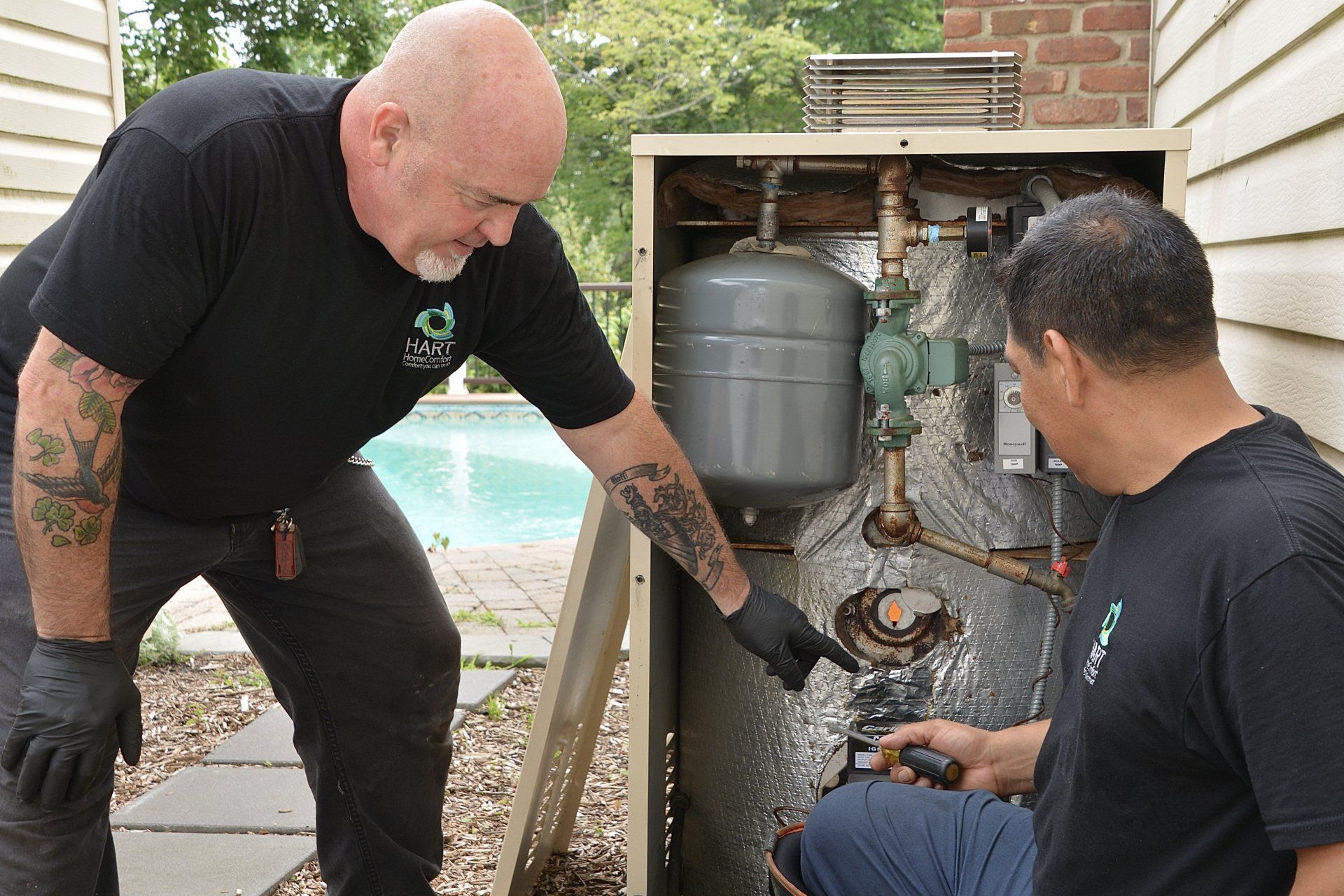 A man teaching how to fix a water tank