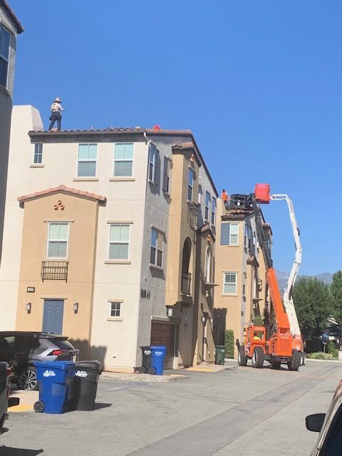A man is working on the roof of a building