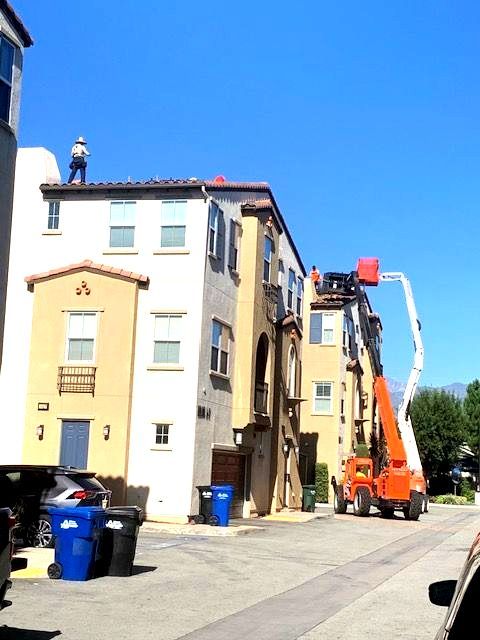 A man is working on the roof of a building