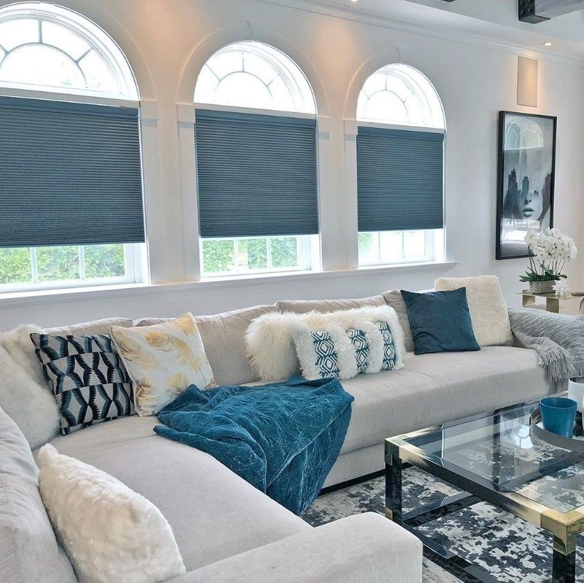a living space with sofa and window blinds