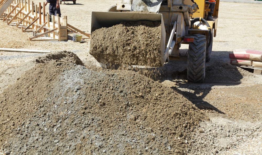 Front-end Loader Dumping Dirt and Gravel Onto a Pile — Salisbury Concrete Contractors In Ocean Shores, NSW