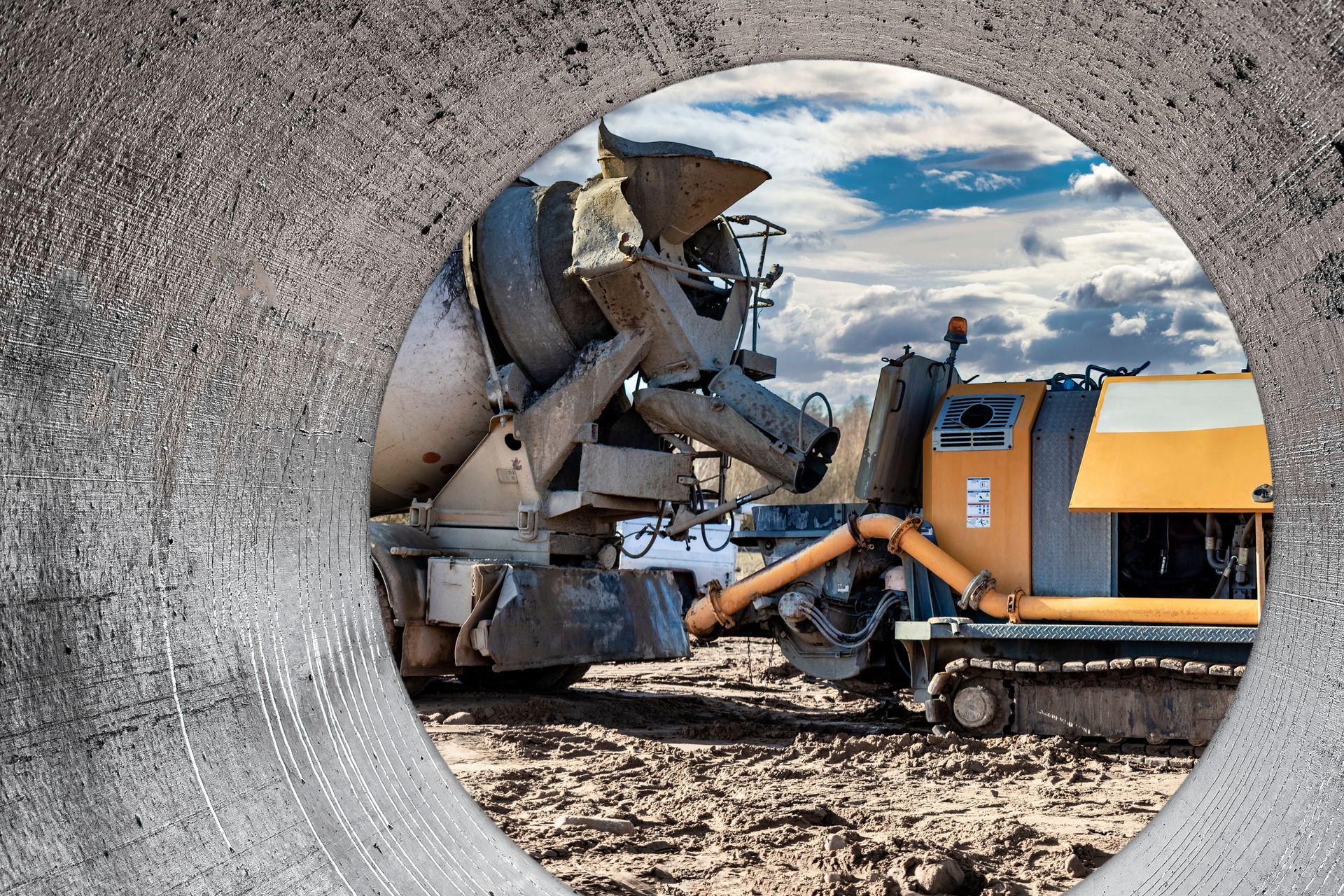 Concrete Mixer Pouring Into a Yellow Cement Pump Machine — Salisbury Concrete Contractors In Ballina, NSW