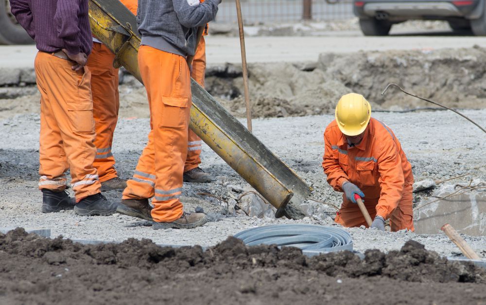 Construction Workers Pouring Concrete on a Gravel Base — Salisbury Concrete Contractors In Tweed Heads, NSW