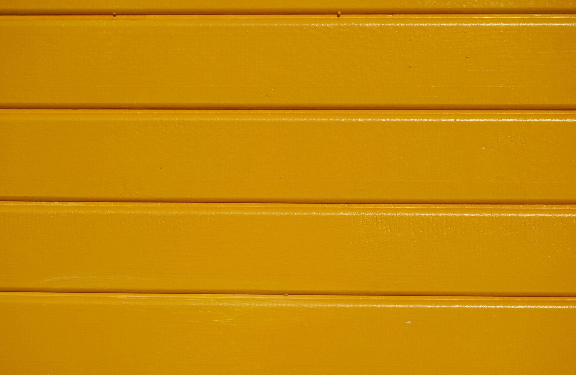 A close up of a yellow wooden wall.