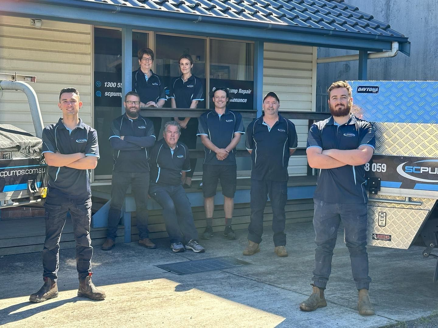 SC Pumps team posing for a picture in front of a building.