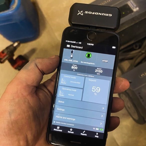 A person is holding a cell phone with the number 59 on the screen