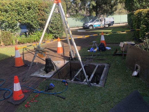 Confined space entry equipment set up over a pump pit access point