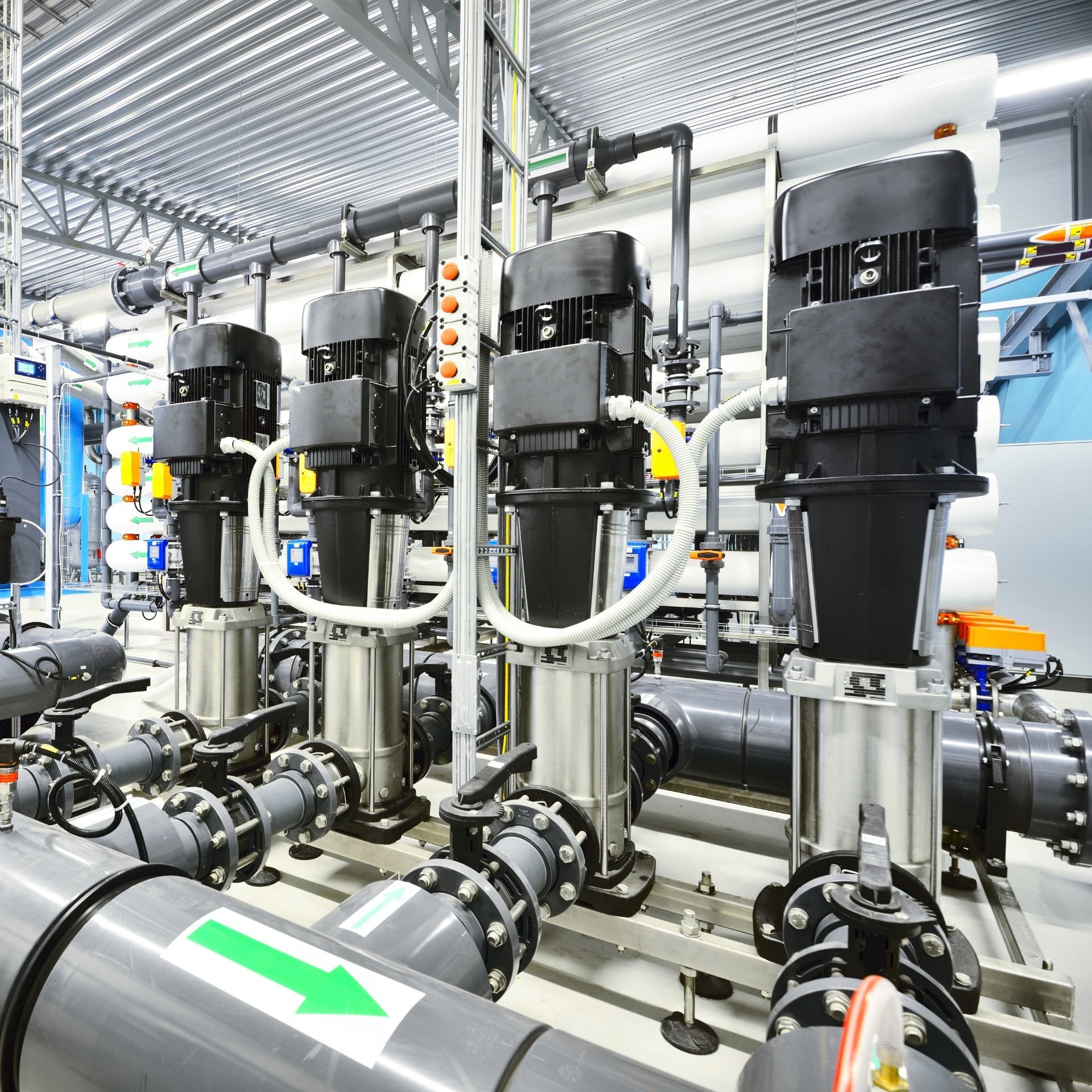 Industrial water treatment equipment with pumps and piping.