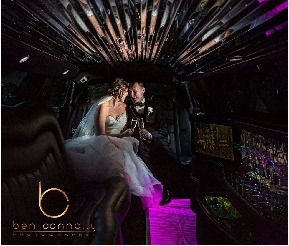 Newly Wed Couple With Wine Inside The Limo — Superstretch300 Limousines in Golden Beach, QLD