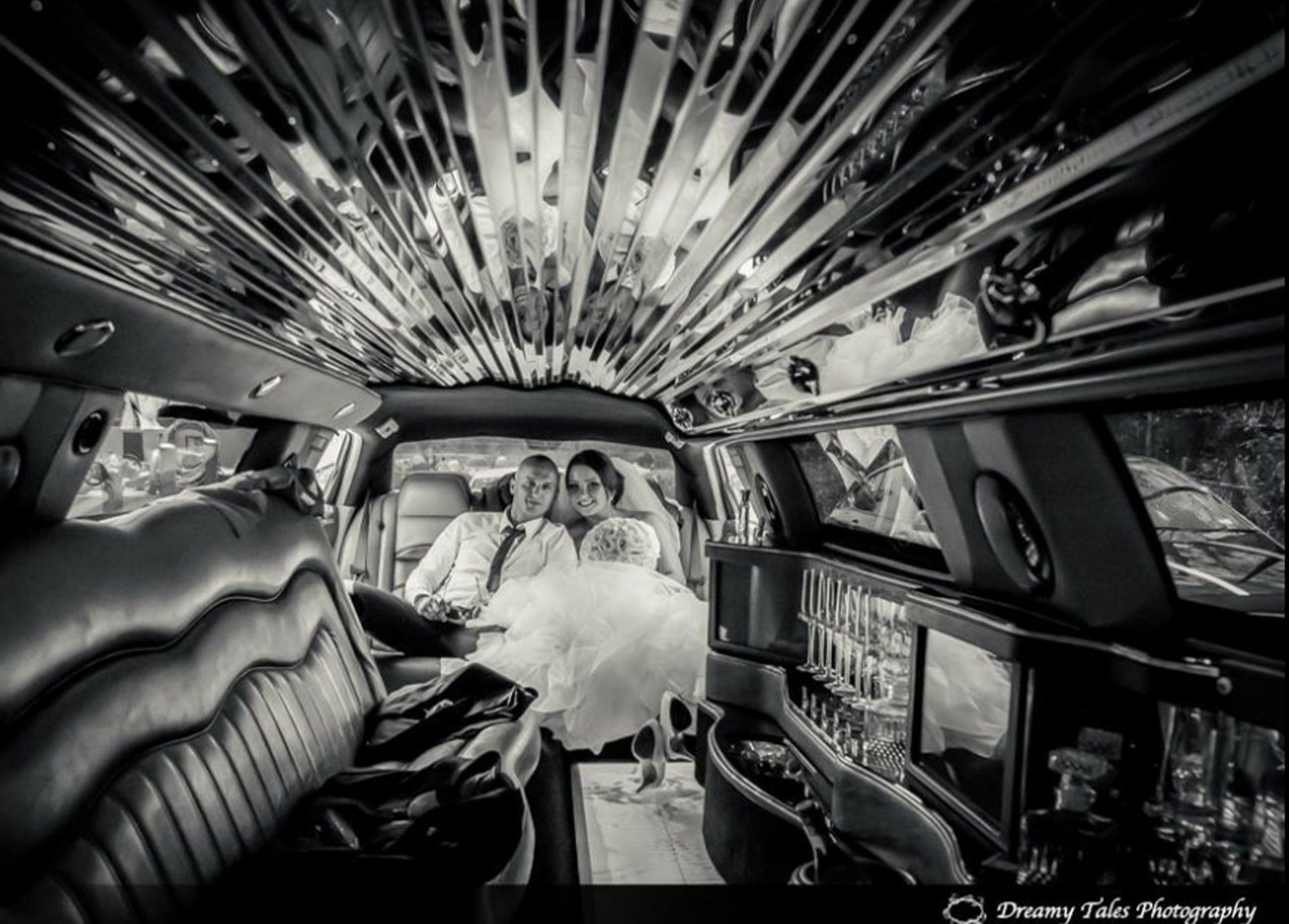 Black And White Photo Of A Happy Wedding Couple Sitting In A Limousine — Superstretch300 Limousines in Golden Beach, QLD